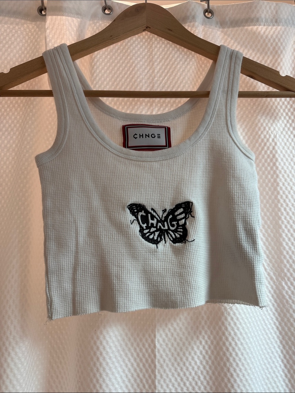 CHNGE White Waffle Crochet Crop Tank with Black Butterfly Emblem